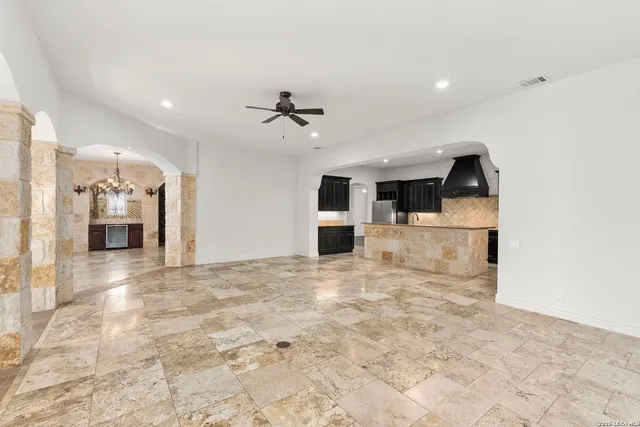 a view of a kitchen with a sink and refrigerator