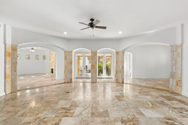 a view of a livingroom with a fireplace and a chandelier