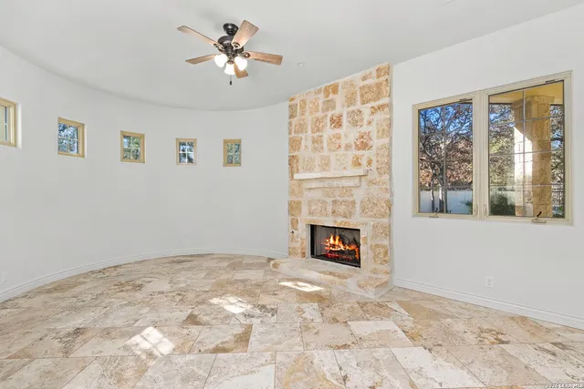 a living room with furniture fireplace and a large window