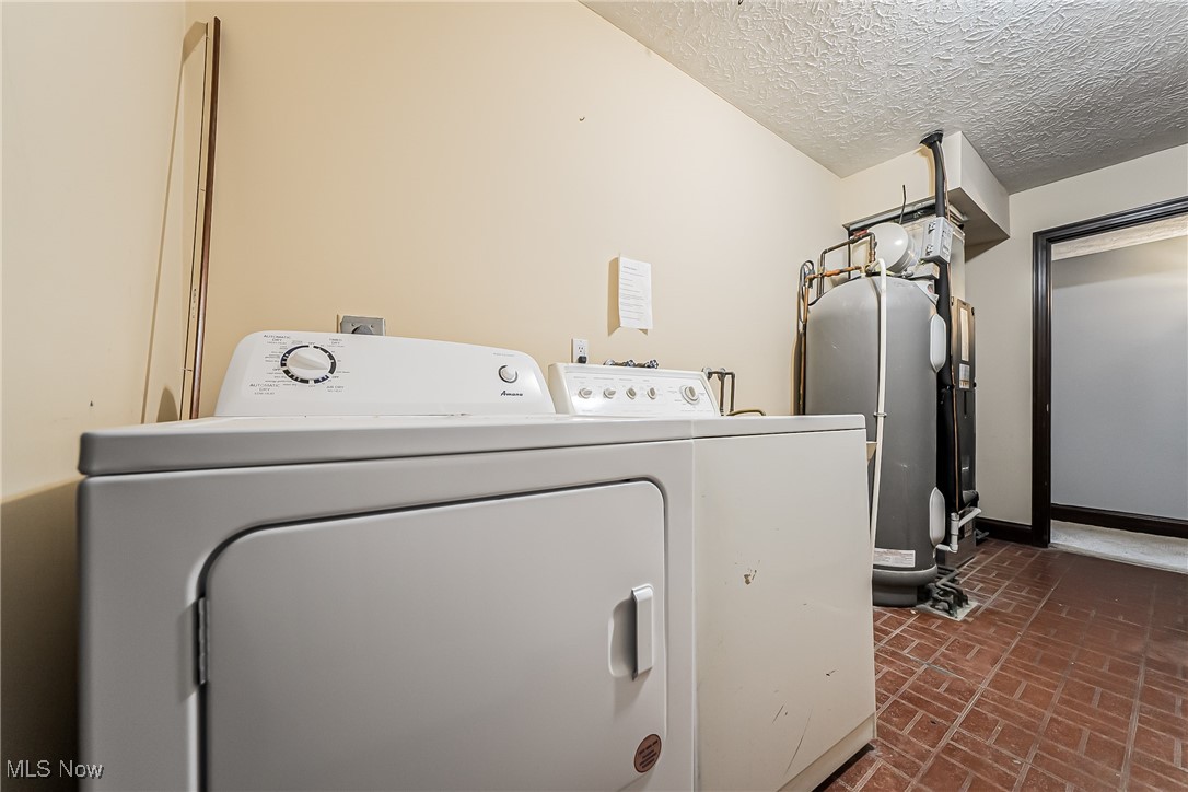 43385 Kipton Nickle Plate Road Lagrange, OH 44050 - Photo 31 of 37 Clothes washing area with washer and clothes dryer and a textured ceiling