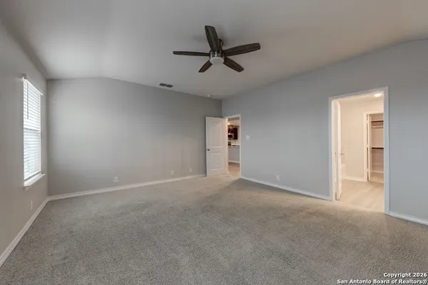 a view of a livingroom with a ceiling fan and window