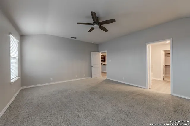 a view of a livingroom with a ceiling fan and window