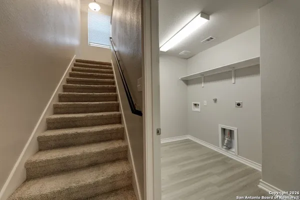 a view of an entryway with wooden floor