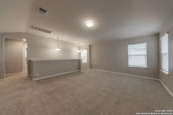 an empty room with a empty space and windows