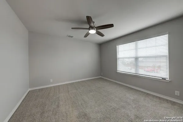 an empty room with windows and closet