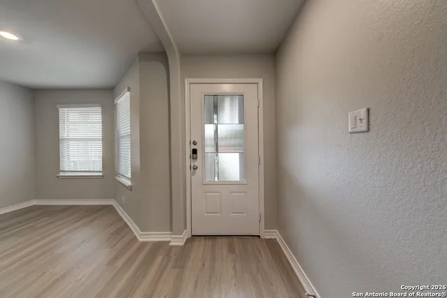 wooden floor in an empty room with a window