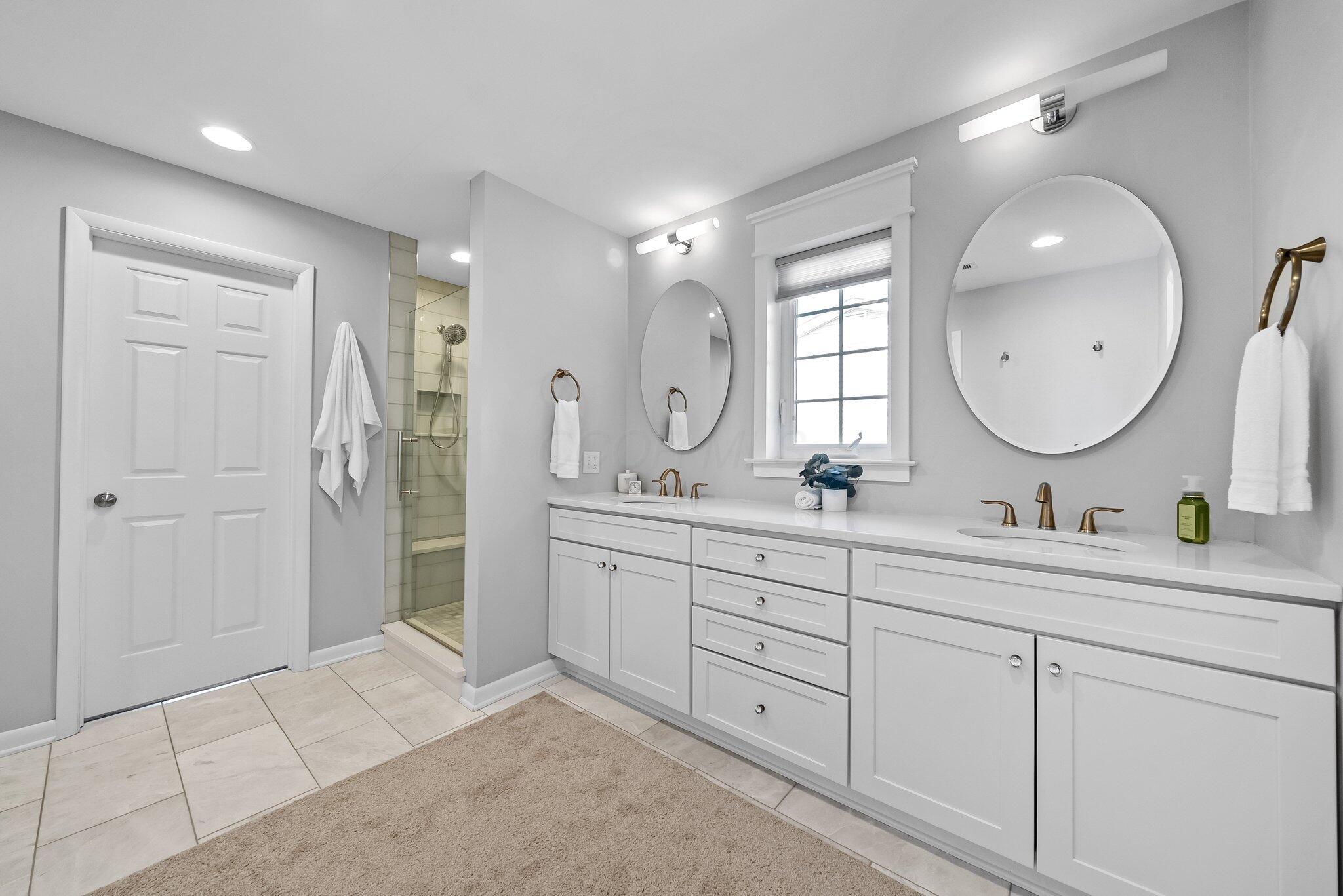 1269 Windham Road Columbus, OH 43220 - Photo 26 of 82 The updated primary bathroom has a double vanity and large shower.