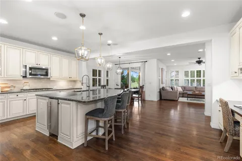 a kitchen with center island cabinets and wooden floor