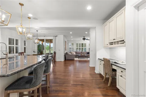 a large kitchen with a table and chairs