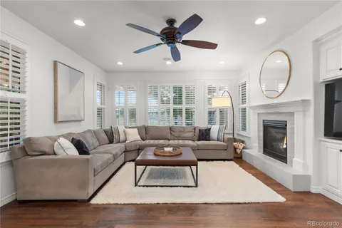 a living room with furniture a window and a fireplace