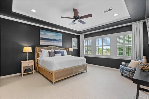 a bedroom with a bed couch and window