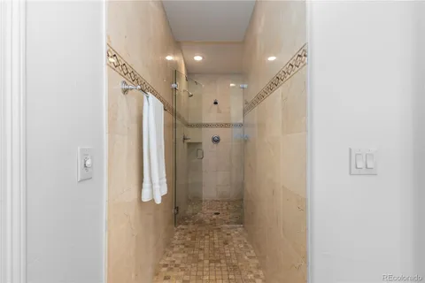 a bathroom with a shower and a glass door