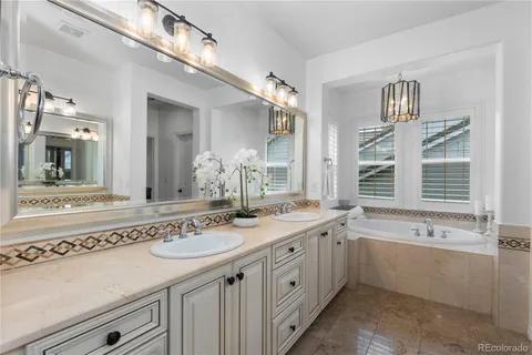 a spacious bathroom with a sink double vanity and a bathtub