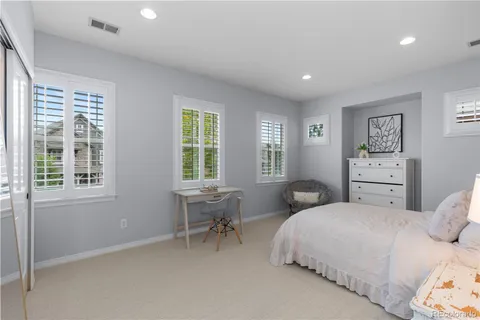 a bedroom with two beds and a window