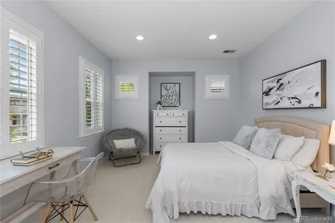 a bedroom with a bed and a chair