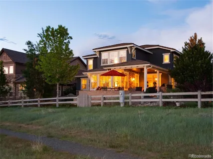 a view of a house with a big yard and sitting area