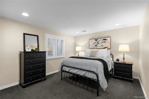 a bedroom with a bed and a dresser
