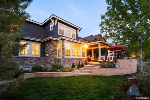 a front view of a house with swimming pool and porch