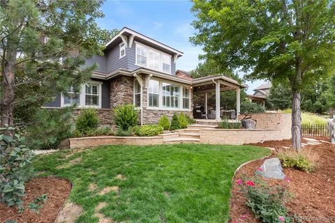 a front view of a house with yard and green space