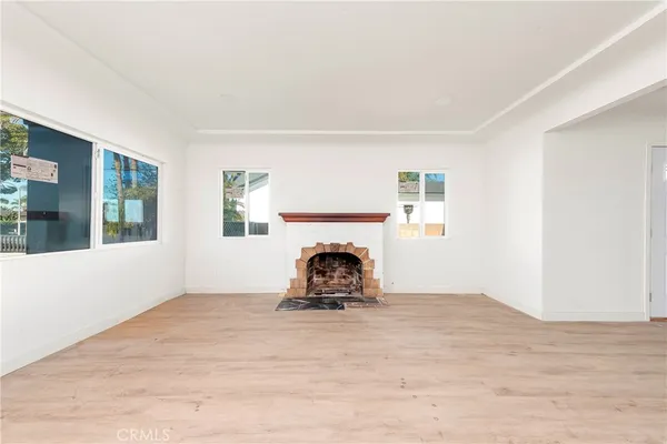 a room with a fireplace and window
