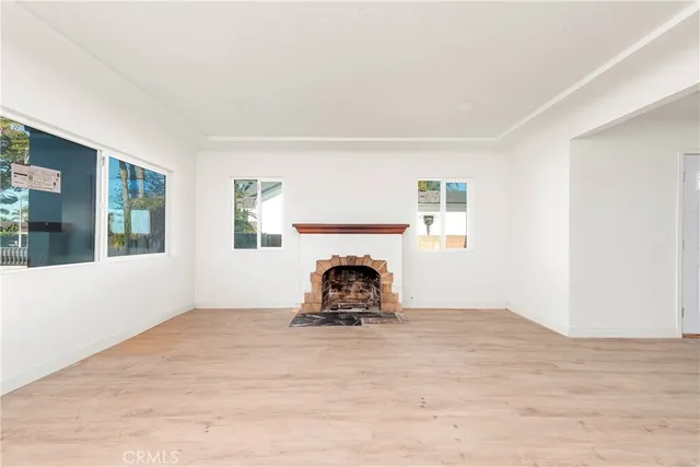 a room with a fireplace and window