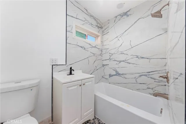 a bathroom with a sink a toilet and bathtub