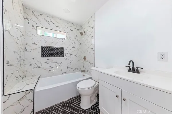 a bathroom with a bathtub and sink