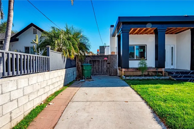 a view of house with backyard and patio
