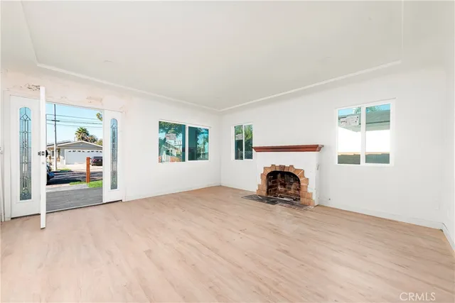 an empty room with furniture and fireplace