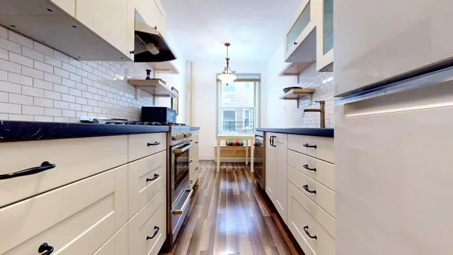 a kitchen with stainless steel appliances a sink stove and cabinets