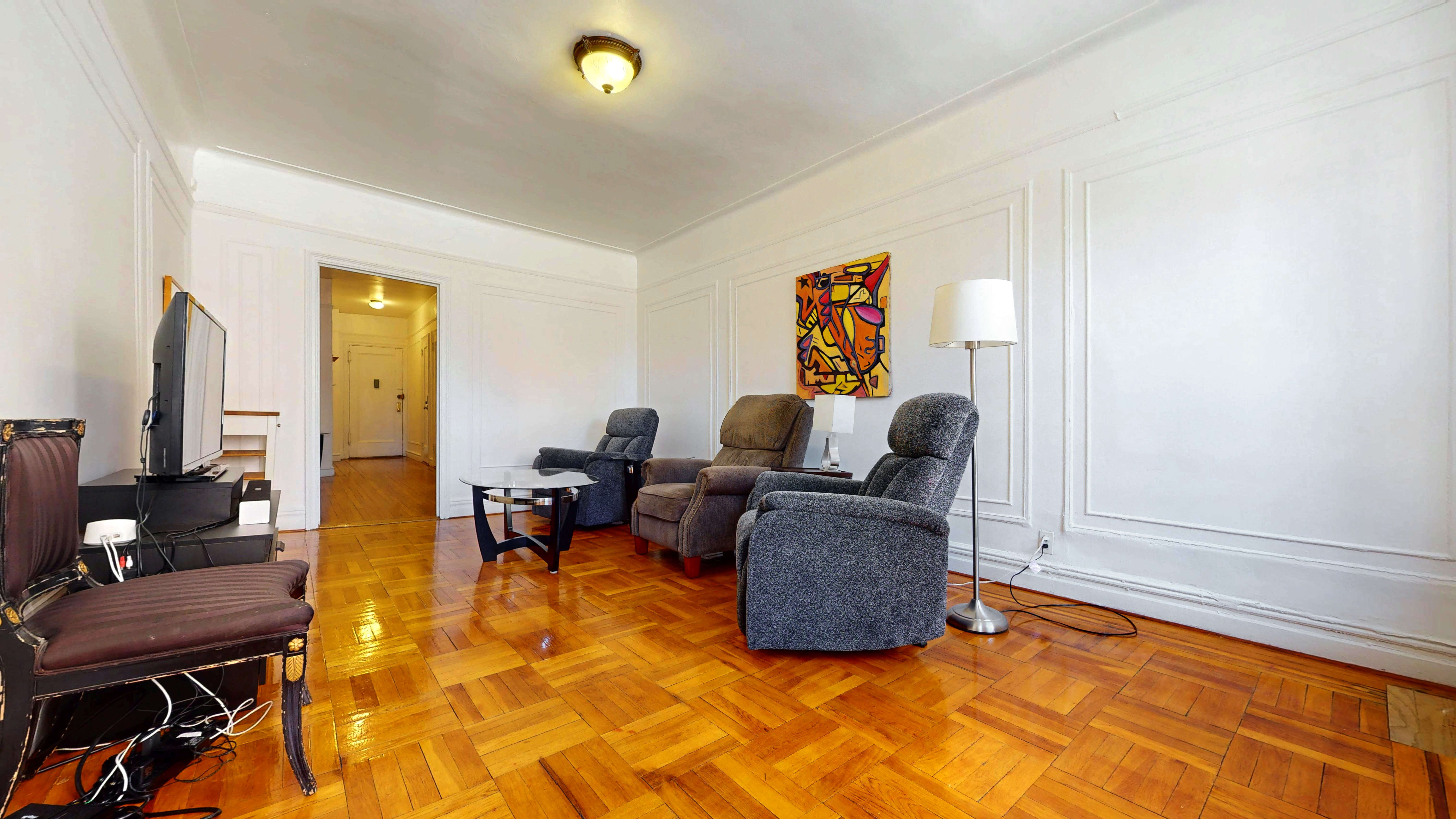 2081 Cruger Avenue, Unit 2K Bronx, NY 10462 - Photo 7 of 12 a living room with furniture and a flat screen tv