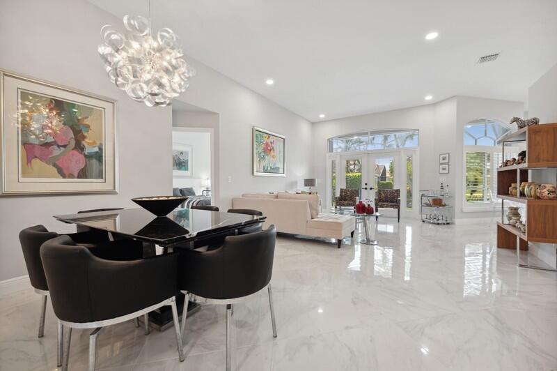 23337 Torre Circle Boca Raton, FL 33433 - Photo 3 of 20 a living room with furniture a chandelier and a painting