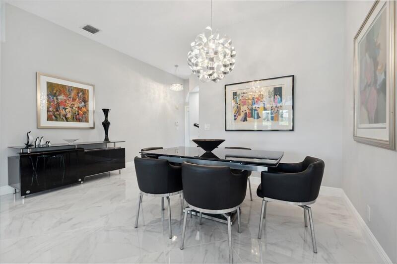23337 Torre Circle Boca Raton, FL 33433 - Photo 4 of 20 a living room with furniture a chandelier and a painting