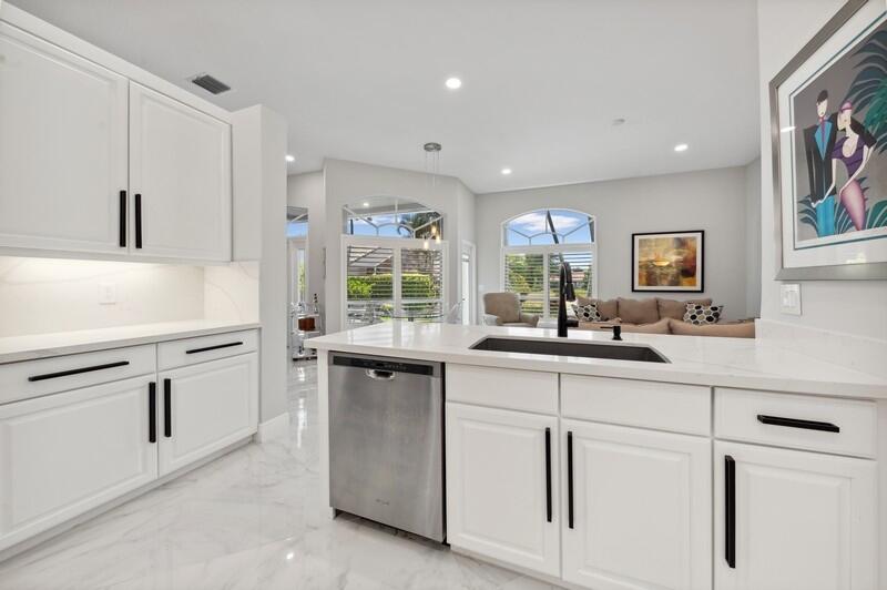 23337 Torre Circle Boca Raton, FL 33433 - Photo 7 of 20 a kitchen with white cabinets and sink