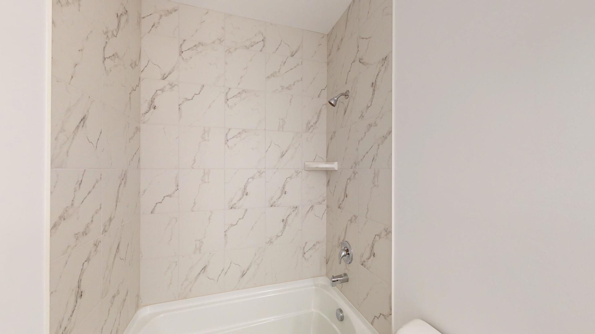 1S980 Deerpath Road Batavia, IL 60510 - Photo 14 of 43 a bathroom with a bathtub