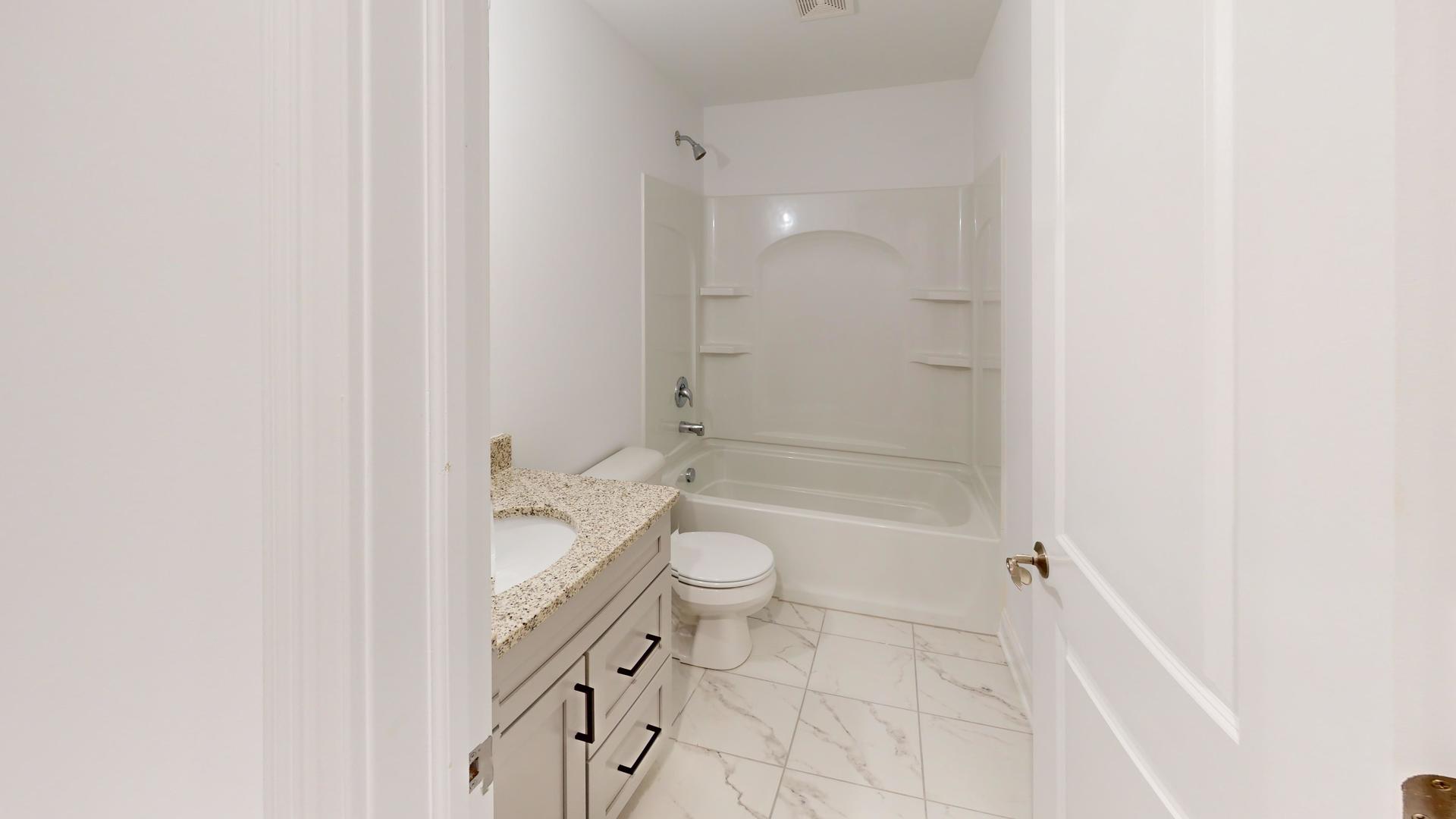 1S980 Deerpath Road Batavia, IL 60510 - Photo 28 of 43 a bathroom with a granite countertop toilet a sink and a mirror