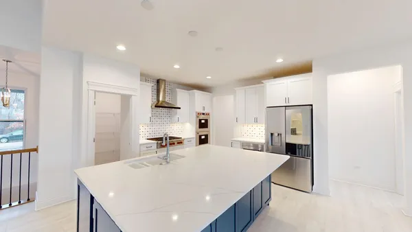 a large kitchen with a table and chairs