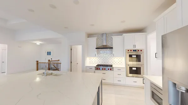 a kitchen that has a lot of cabinets in it and appliances
