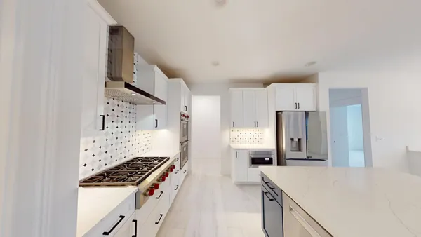 a kitchen with cabinets and a stove top oven