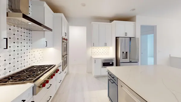 a kitchen with stainless steel appliances a stove a sink and a refrigerator