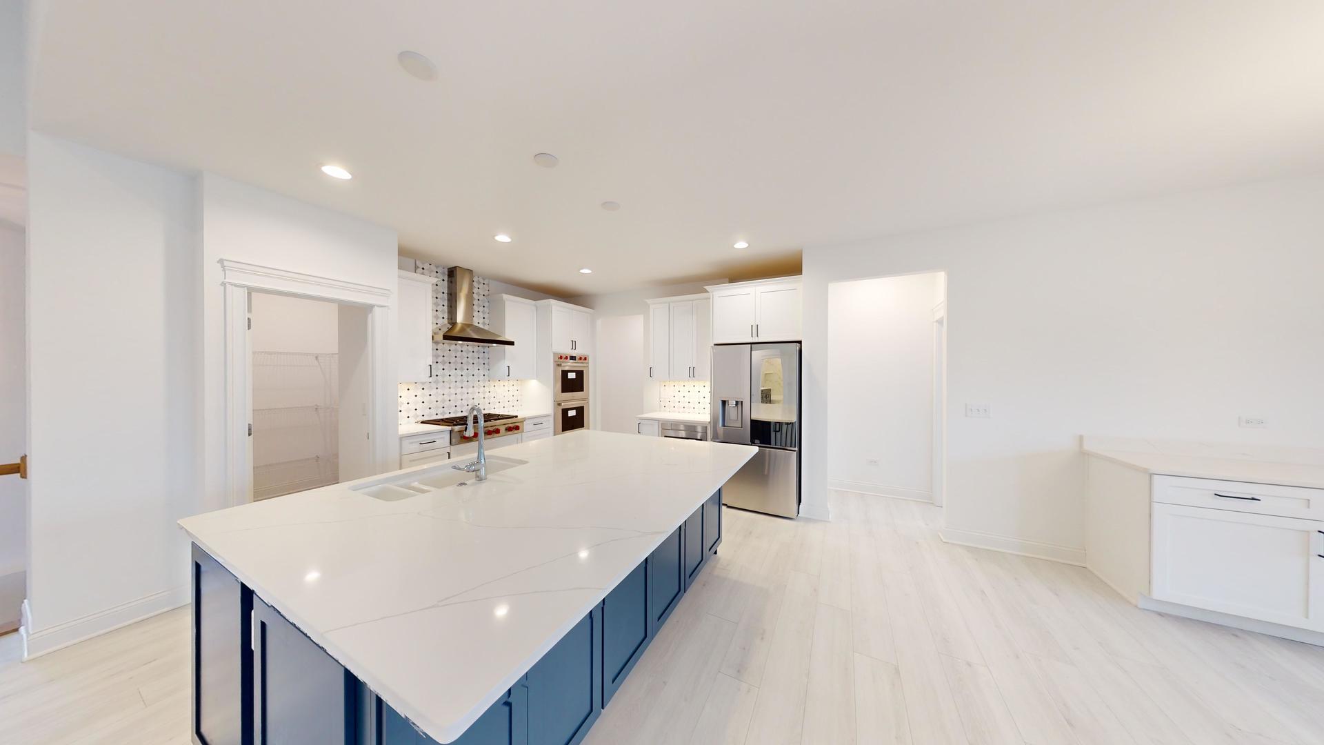 1S980 Deerpath Road Batavia, IL 60510 - Photo 8 of 43 a large white kitchen with a stove a sink a refrigerator and white cabinets with wooden floor