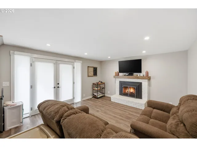 a living room with furniture a fireplace and a flat screen tv