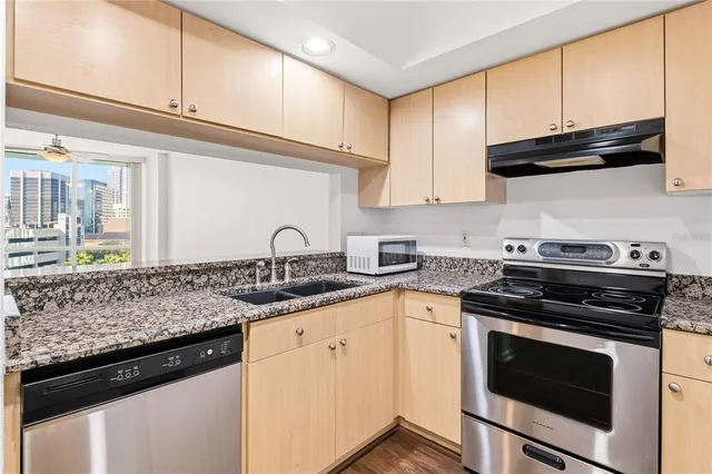 a kitchen with granite countertop stainless steel appliances and cabinets