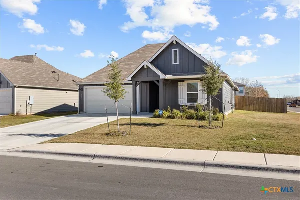 a house that has a tree in front of it