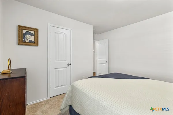 a bedroom with a bed and a table