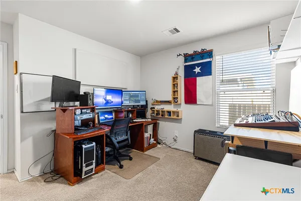 a room with furniture a flat screen tv and a window