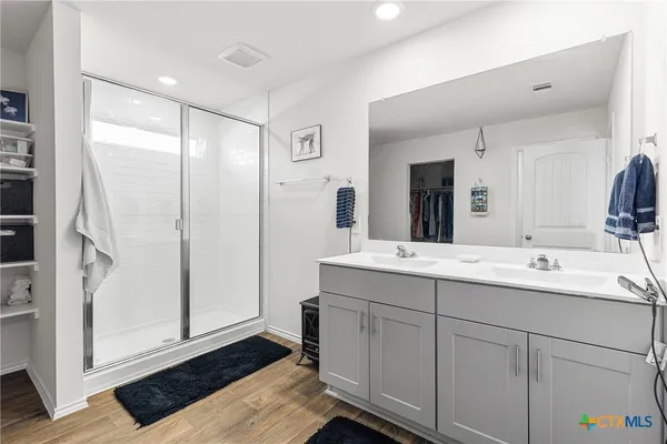 a bathroom with a double vanity sink and mirror