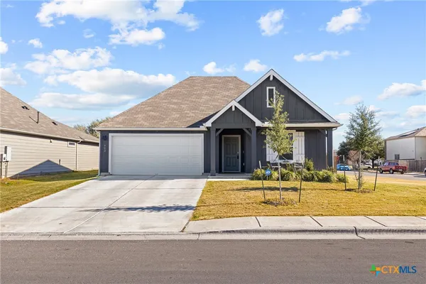 a view of a house with swimming pool and a yard