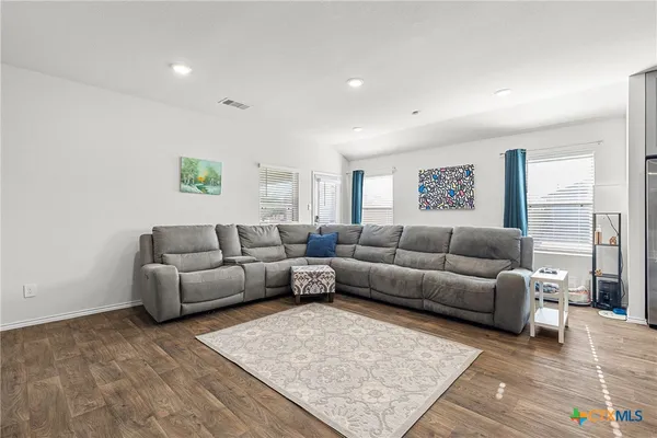 a living room with furniture and painting on the wall