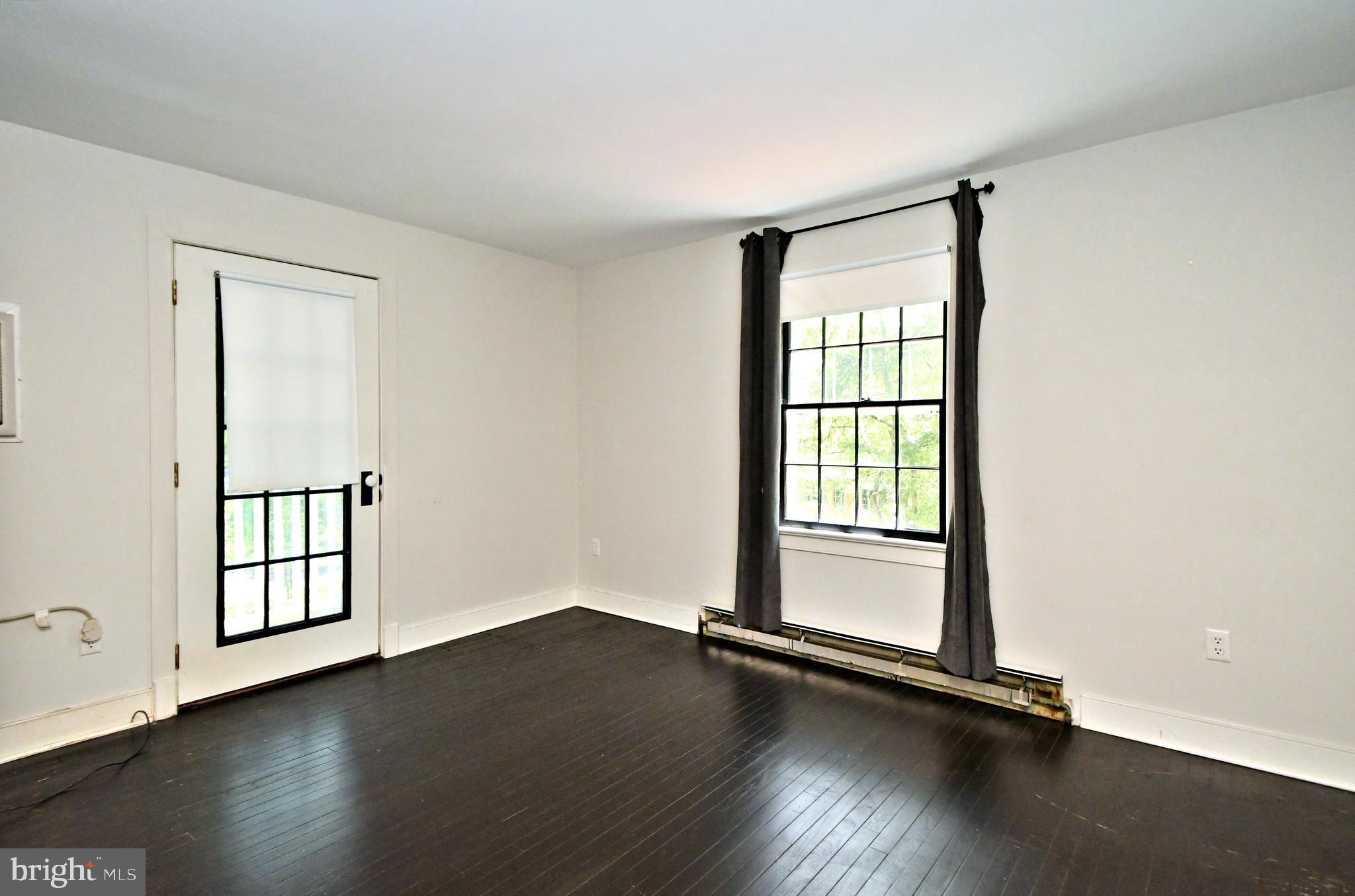 143 Old York Road New Hope, PA 18938 - Photo 20 of 70 a view of an empty room with wooden floor and a window